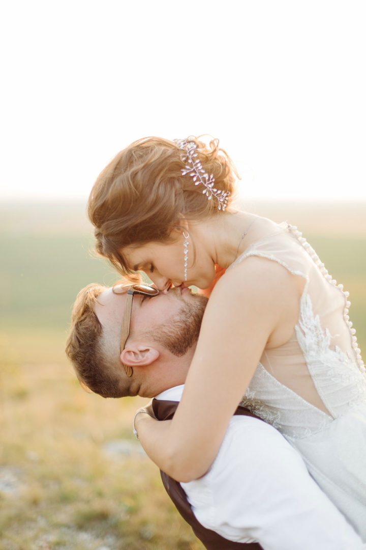 loving-couple-wedding-newlyweds-outside-sunset-beautiful-summer-day.jpg
